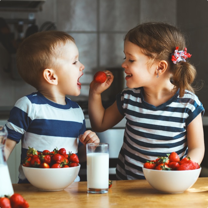 Kids eating strawberries