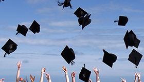 Students throwing caps in the air