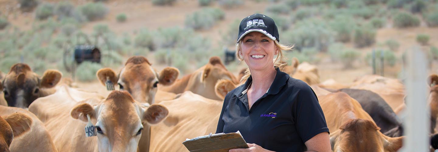 Woman posing with cows