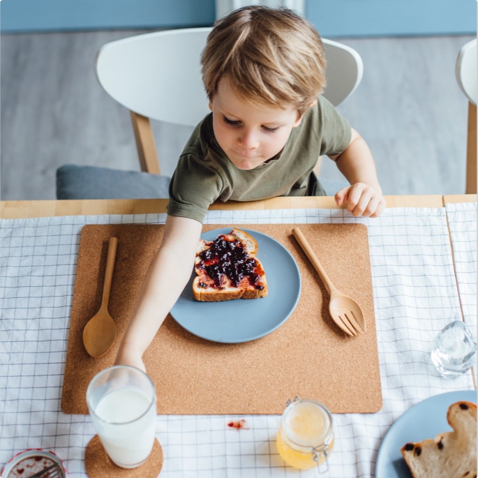 kid eating toast with milk