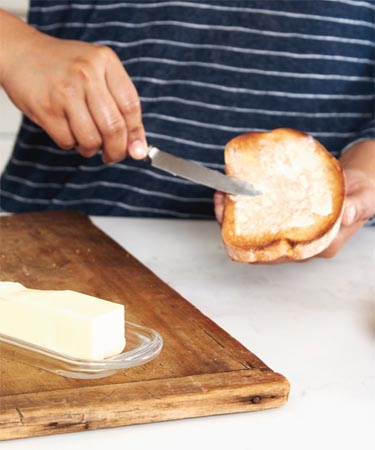 Woman buttering toast