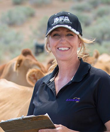 Woman standing with cows