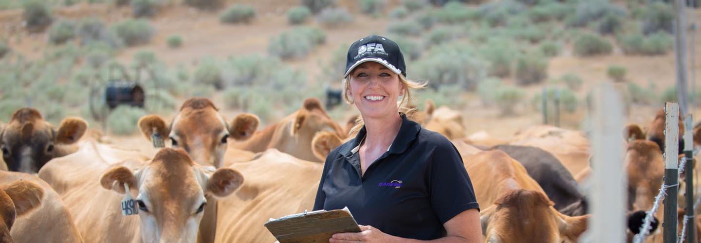 Woman standing with cows