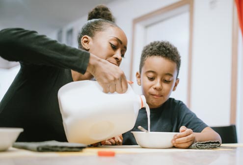 Woman pouring milk in a bowl