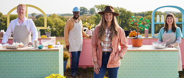 Nerd Herd scientist, engineer, farmer, and nutritionist stand together smiling in an outdoor kitchen.