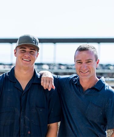 Farmers standing next to tractor