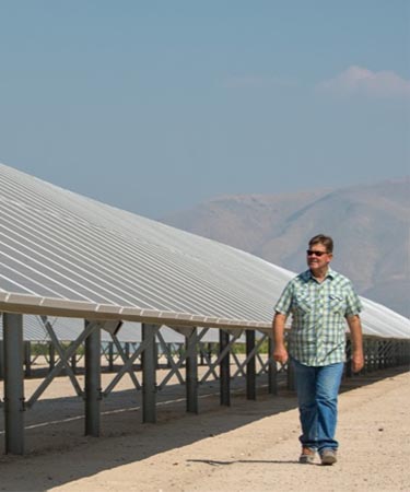 Man walking by the solar panels