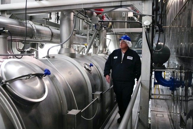 Man walking the milk plant