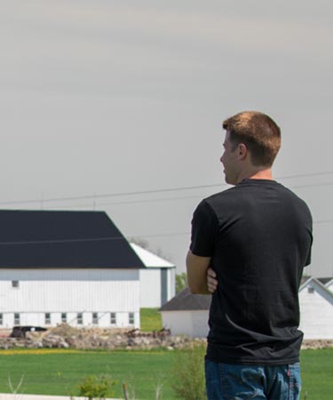 Farmer overlooking landscape