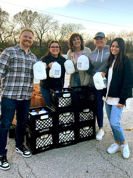 DFA employees volunteer their time and provide milk to families in need through local food drives.