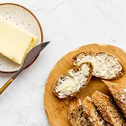 AdobeStock_259550843.webp Buttered bread on a plate.